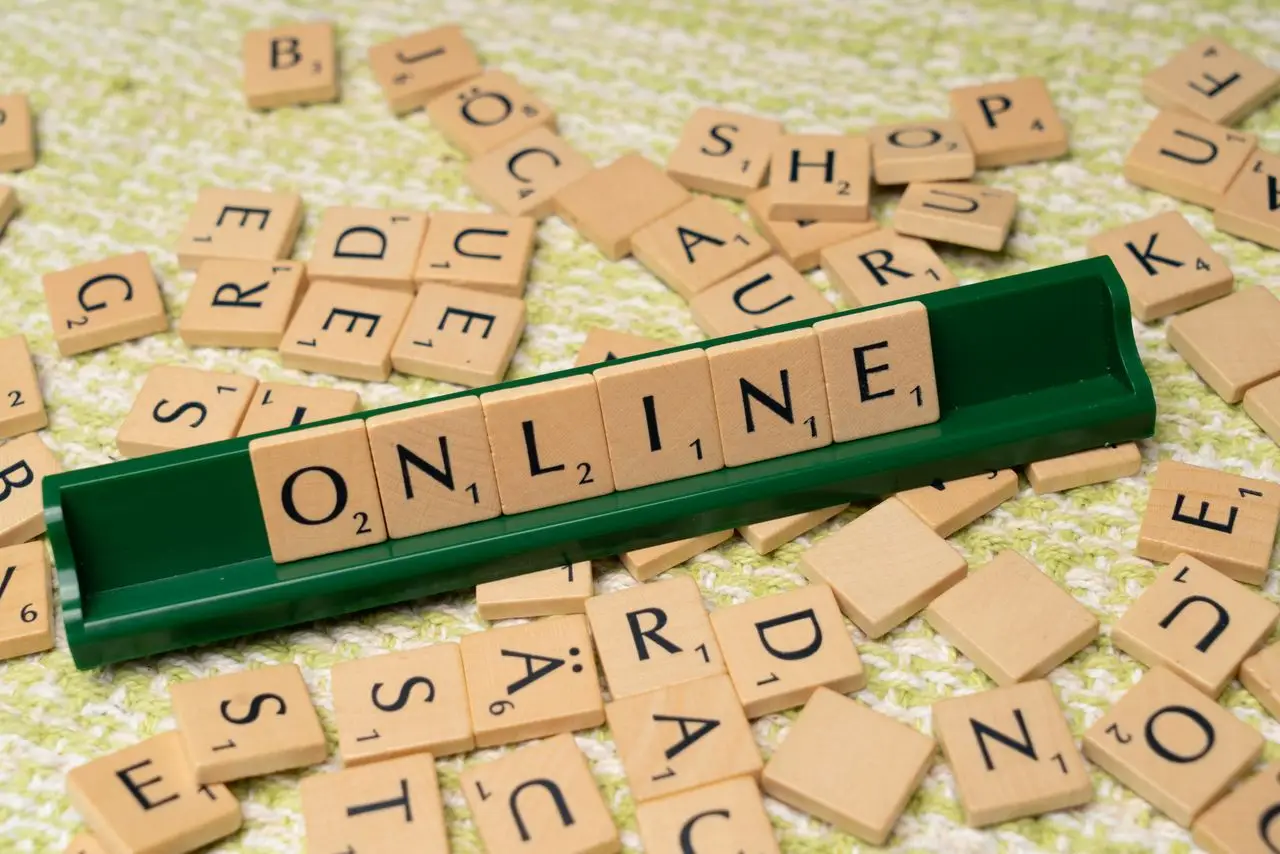 Crafting Captivating Headlines: Your awesome post title goes here Scrabble tiles spelling 'online' on a green tray amidst scattered tiles, symbolizing digital connectivity and language.